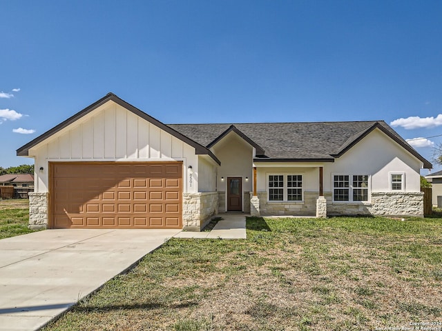 8501 Utopia Blvd, Selma, TX 78154 - view of front facade featuring stone siding, a shingled roof, a garage, driveway, and board and batten siding