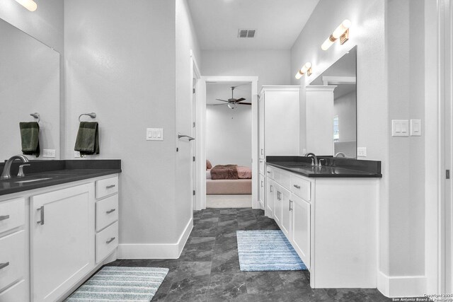 26406 Bubbling Brk, San Antonio, TX 78260 - bathroom featuring ceiling fan, two vanities, ensuite bath, and baseboards