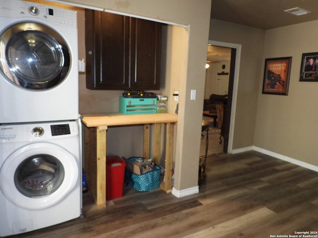155 Scenic Cir, Lakehills, TX 78063 - laundry area with stacked washer and clothes dryer, dark wood-type flooring, and baseboards