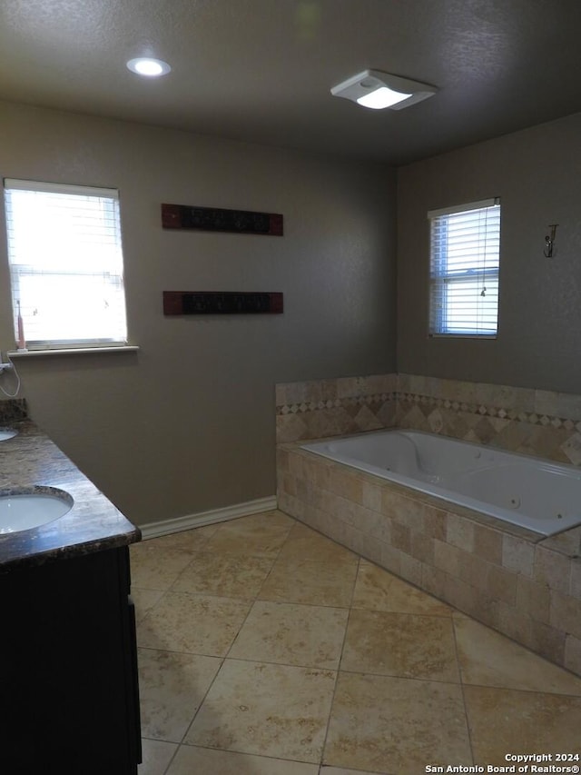 155 Scenic Cir, Lakehills, TX 78063 - bathroom with a jetted tub, double vanity, tile patterned flooring, and baseboards