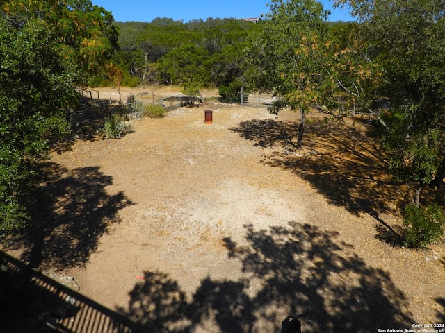 155 Scenic Cir, Lakehills, TX 78063 - view of yard featuring a forest view