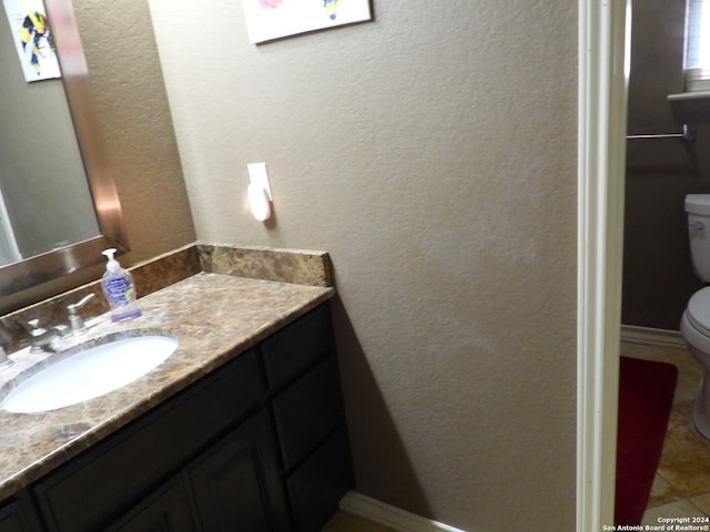 155 Scenic Cir, Lakehills, TX 78063 - bathroom with toilet, vanity, and a textured wall
