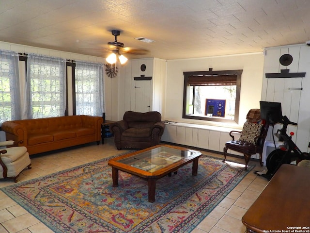 155 Scenic Cir, Lakehills, TX 78063 - living room with plenty of natural light, tile patterned floors, a ceiling fan, and radiator