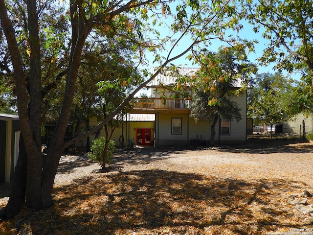 155 Scenic Cir, Lakehills, TX 78063 - back of property with french doors and a wooden deck