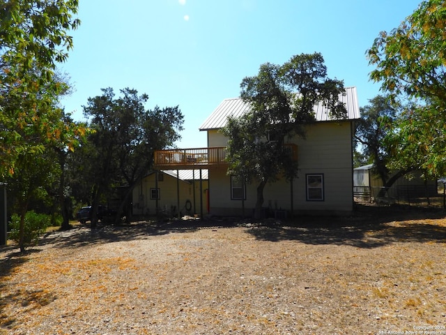 155 Scenic Cir, Lakehills, TX 78063 - rear view of property with metal roof, a deck, and a standing seam roof