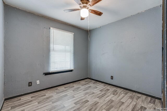 2927 Lasses, San Antonio, TX 78223 - unfurnished room featuring ceiling fan, light wood-style floors, and baseboards