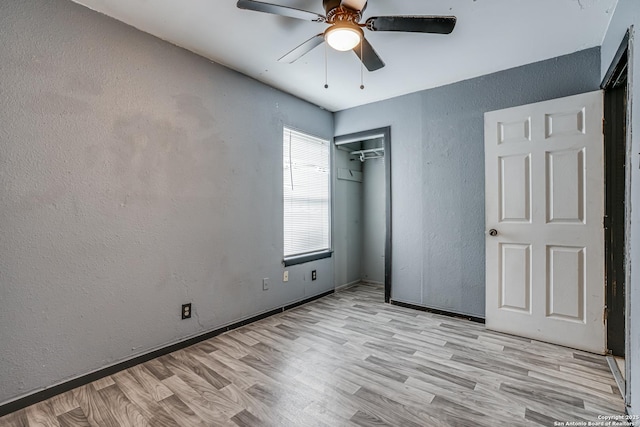 2927 Lasses, San Antonio, TX 78223 - unfurnished bedroom featuring a textured wall, wood finished floors, a closet, a ceiling fan, and baseboards