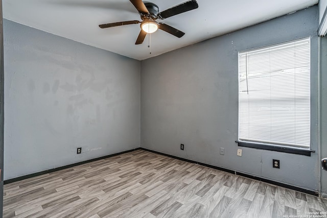 2927 Lasses, San Antonio, TX 78223 - unfurnished room with light wood finished floors, ceiling fan, and baseboards