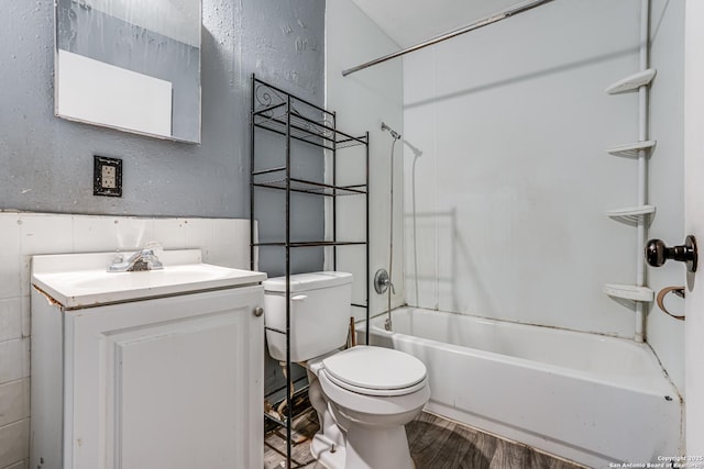 2927 Lasses, San Antonio, TX 78223 - bathroom with toilet, shower / tub combination, vanity, wood finished floors, and a wainscoted wall