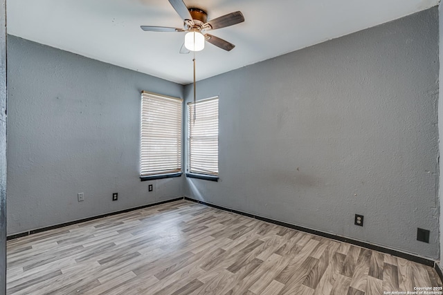 2927 Lasses, San Antonio, TX 78223 - empty room featuring wood finished floors, a ceiling fan, baseboards, and a textured wall