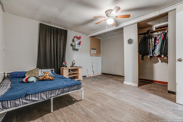 2927 Lasses, San Antonio, TX 78223 - bedroom featuring wood finished floors, baseboards, a wall mounted air conditioner, and a ceiling fan