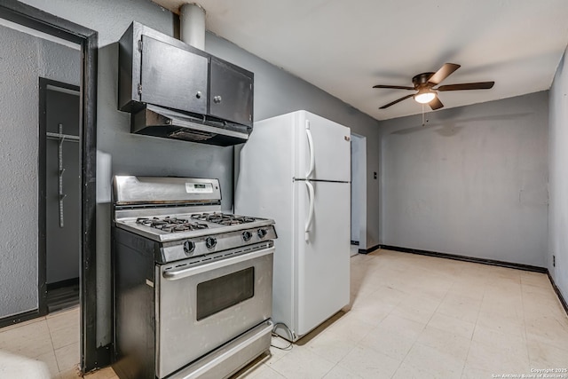 2927 Lasses, San Antonio, TX 78223 - kitchen featuring stainless steel range with gas stovetop, under cabinet range hood, freestanding refrigerator, ceiling fan, and baseboards