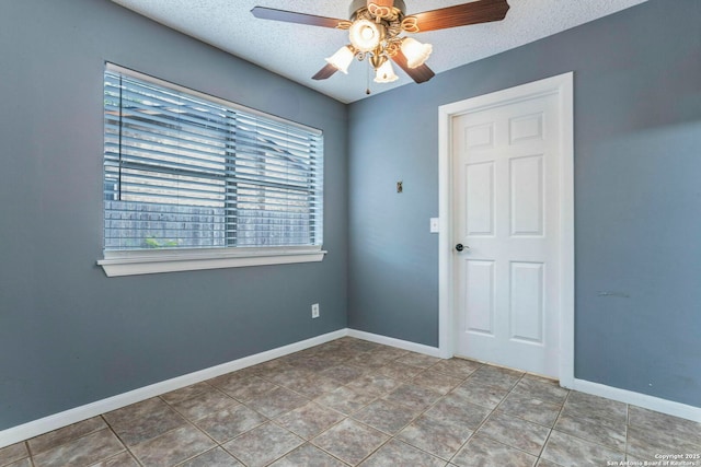 210 Cardinal, New Braunfels, TX 78130 - spare room featuring plenty of natural light, a textured ceiling, a ceiling fan, and baseboards