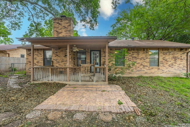 210 Cardinal, New Braunfels, TX 78130 - view of front of house featuring a chimney, ceiling fan, brick siding, and a patio area