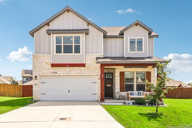 4902 Oxbow Bnd, Saint Hedwig, TX 78152 - view of front of house with stone siding, board and batten siding, a garage, and covered porch