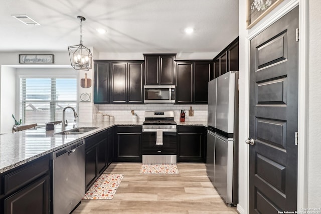 4902 Oxbow Bnd, Saint Hedwig, TX 78152 - kitchen featuring stainless steel appliances, a sink, tasteful backsplash, light stone countertops, and recessed lighting
