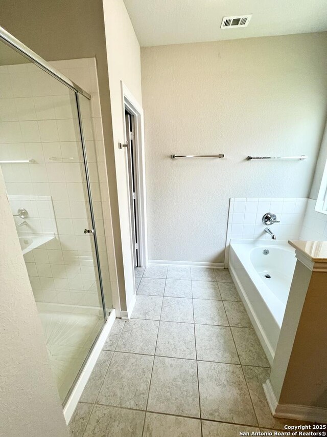 4823 Cambridge Park, Converse, TX 78109 - bathroom featuring a shower stall, a bath, tile patterned flooring, and baseboards