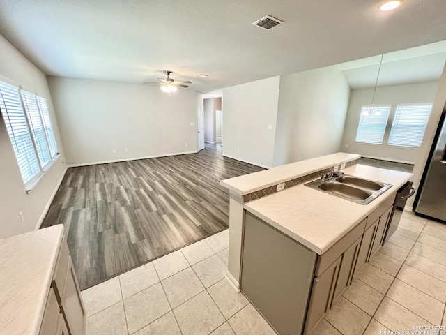 4823 Cambridge Park, Converse, TX 78109 - kitchen with a sink, light tile patterned flooring, ceiling fan, a kitchen island with sink, and light countertops
