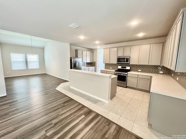 4823 Cambridge Park, Converse, TX 78109 - kitchen with stainless steel appliances, decorative backsplash, light countertops, a chandelier, and light wood-type flooring