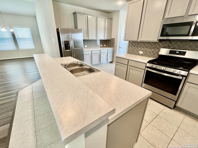 4823 Cambridge Park, Converse, TX 78109 - kitchen featuring appliances with stainless steel finishes, a sink, a center island with sink, and light tile patterned floors