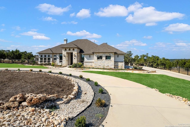 1132 Towhee Trl, New Braunfels, TX 78132 - view of front of property featuring stone siding, a chimney, roof with shingles, and curved driveway