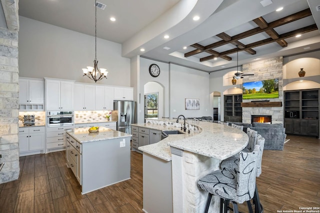 1132 Towhee Trl, New Braunfels, TX 78132 - kitchen featuring a sink, a large island, arched walkways, ceiling fan, and stainless steel appliances