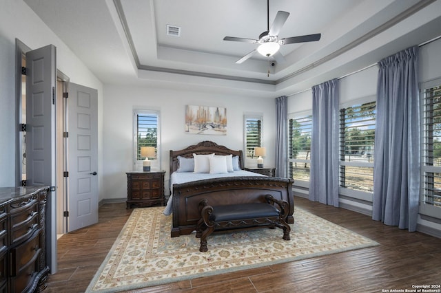 1132 Towhee Trl, New Braunfels, TX 78132 - bedroom with a raised ceiling, dark wood-style floors, a ceiling fan, and baseboards