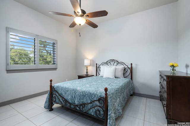 1132 Towhee Trl, New Braunfels, TX 78132 - bedroom featuring baseboards, light tile patterned flooring, and ceiling fan