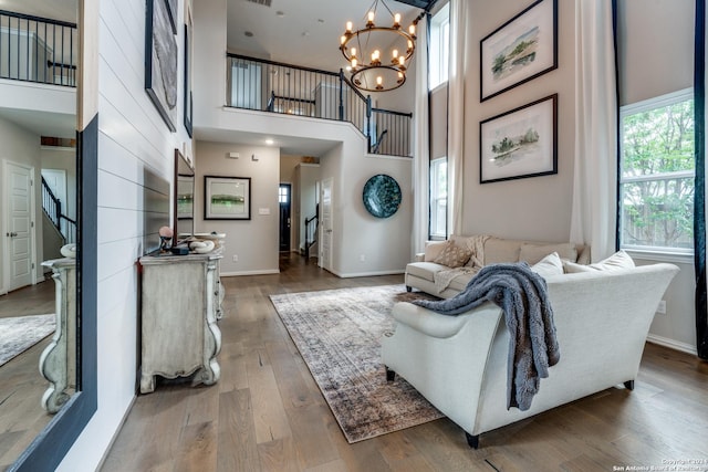 2096 Cowan, New Braunfels, TX 78132 - living room featuring stairway, a high ceiling, wood finished floors, a chandelier, and baseboards