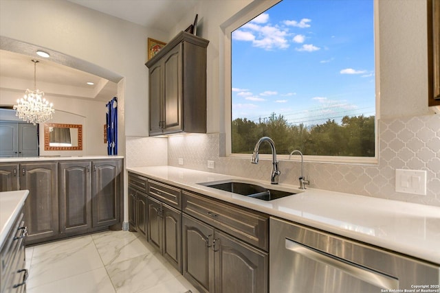 427 Bella Montagna Cir, Austin, TX 78734 - kitchen featuring dishwasher, a sink, light countertops, a chandelier, and light marble finish floors