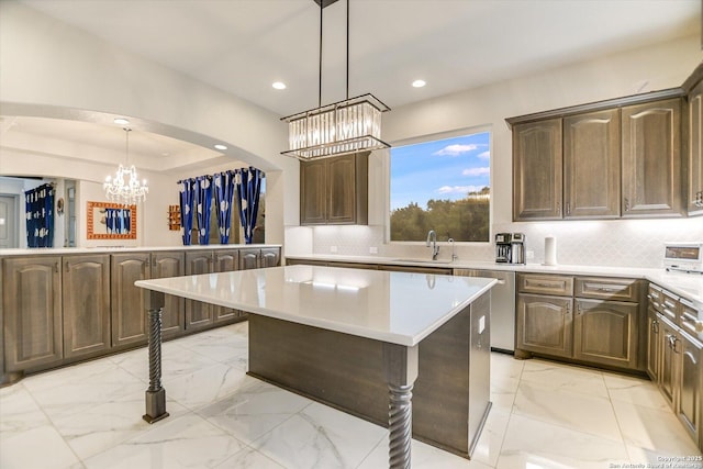 427 Bella Montagna Cir, Austin, TX 78734 - kitchen with a chandelier, dishwasher, light marble finish flooring, light countertops, and a kitchen island