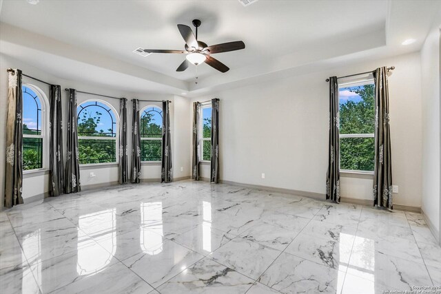427 Bella Montagna Cir, Austin, TX 78734 - empty room with a raised ceiling, healthy amount of natural light, baseboards, and ceiling fan