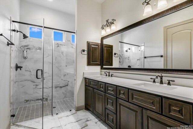 427 Bella Montagna Cir, Austin, TX 78734 - bathroom with marble look tiles, a marble finish shower, double vanity, and baseboards