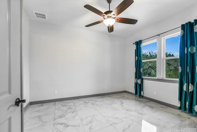 427 Bella Montagna Cir, Austin, TX 78734 - unfurnished room with baseboards, light marble finish flooring, and a ceiling fan