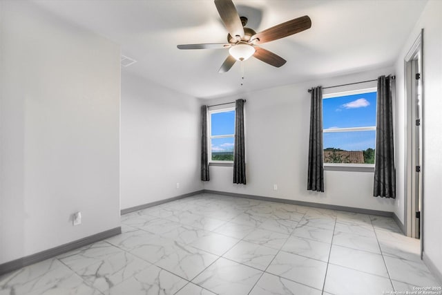 427 Bella Montagna Cir, Austin, TX 78734 - unfurnished room with baseboards, light marble finish flooring, and ceiling fan