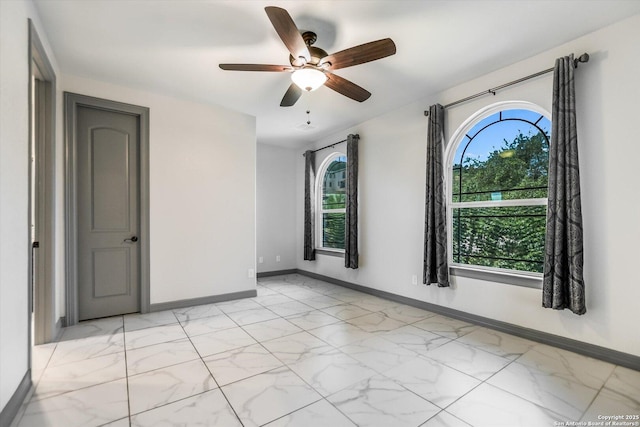 427 Bella Montagna Cir, Austin, TX 78734 - empty room with light marble finish flooring, baseboards, and ceiling fan
