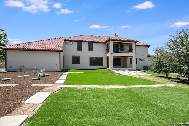 427 Bella Montagna Cir, Austin, TX 78734 - back of property featuring a balcony, a tile roof, a chimney, stucco siding, and a patio area