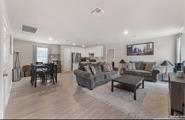 734 Ambush Rdg, San Antonio, TX 78219 - living area with light wood-style flooring and recessed lighting