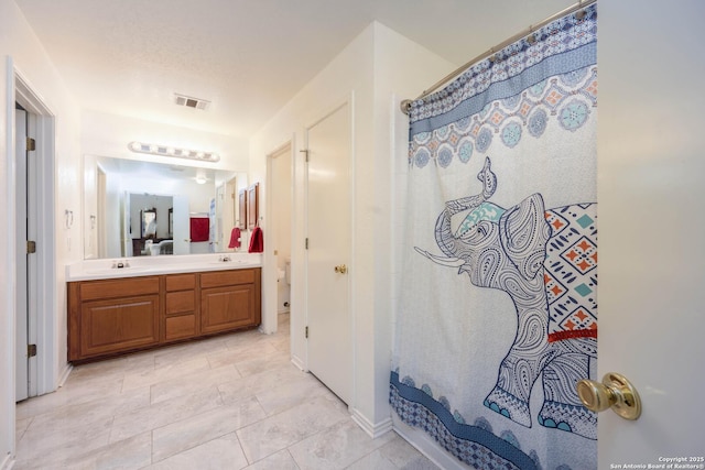 4706 Granite Shls, San Antonio, TX 78244 - full bath with double vanity, a shower with shower curtain, and baseboards