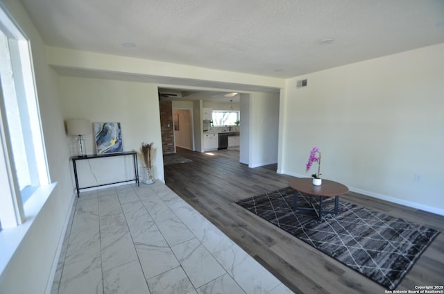 3160 Weil, Marion, TX 78124 - living room with baseboards, marble look tiles, and a textured ceiling