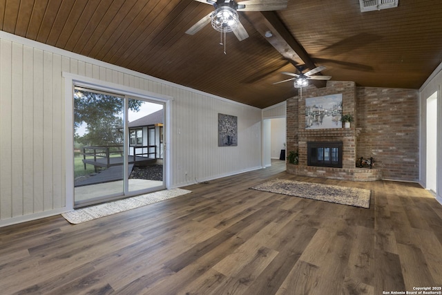 3160 Weil, Marion, TX 78124 - unfurnished living room with ceiling fan, wood finished floors, wood walls, a fireplace, and baseboards
