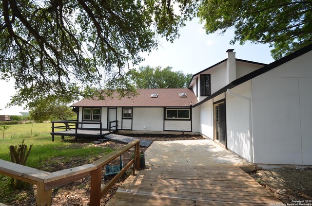 3160 Weil, Marion, TX 78124 - back of house with a wooden deck, a chimney, and a yard