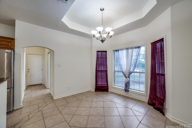 3343 Dove Park Ln, San Antonio, TX 78253 - unfurnished dining area with arched walkways, a chandelier, light tile patterned flooring, and baseboards