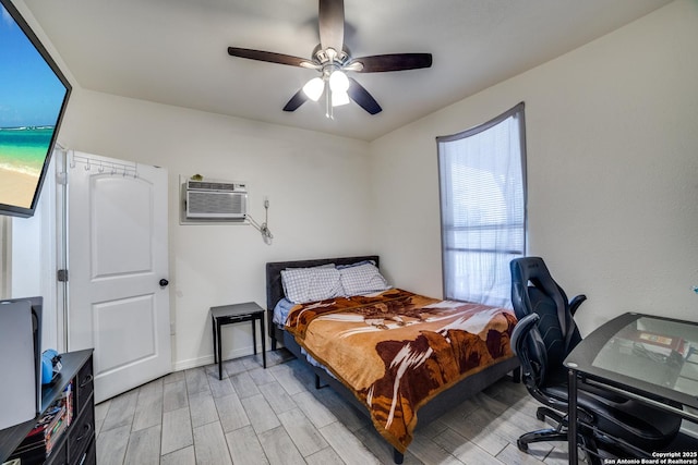 3343 Dove Park Ln, San Antonio, TX 78253 - bedroom featuring a wall unit AC, light wood-style floors, a ceiling fan, and a desk