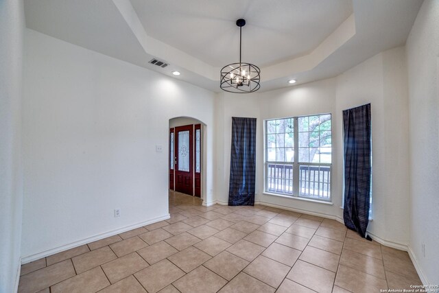 3343 Dove Park Ln, San Antonio, TX 78253 - empty room with arched walkways, a chandelier, light tile patterned flooring, a raised ceiling, and baseboards
