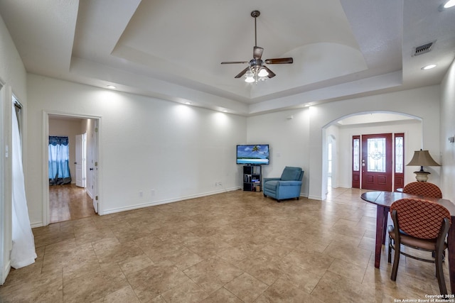 3343 Dove Park Ln, San Antonio, TX 78253 - living room featuring a raised ceiling, arched walkways, ceiling fan, baseboards, and recessed lighting