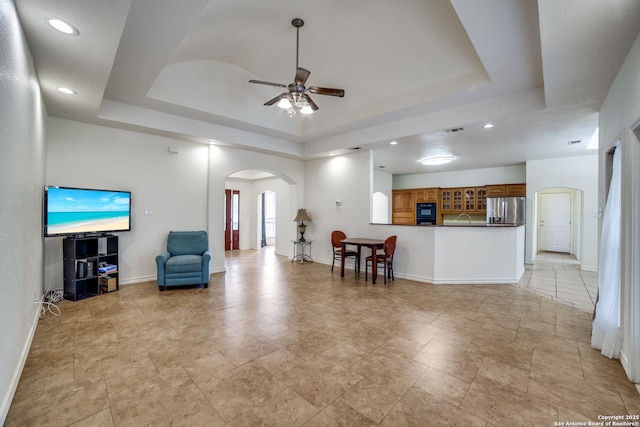3343 Dove Park Ln, San Antonio, TX 78253 - living room featuring arched walkways, a tray ceiling, ceiling fan, and recessed lighting