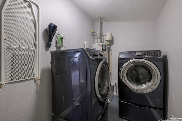1129 N Smith St, San Antonio, TX 78207 - laundry area featuring washer and dryer, water heater, and a textured ceiling