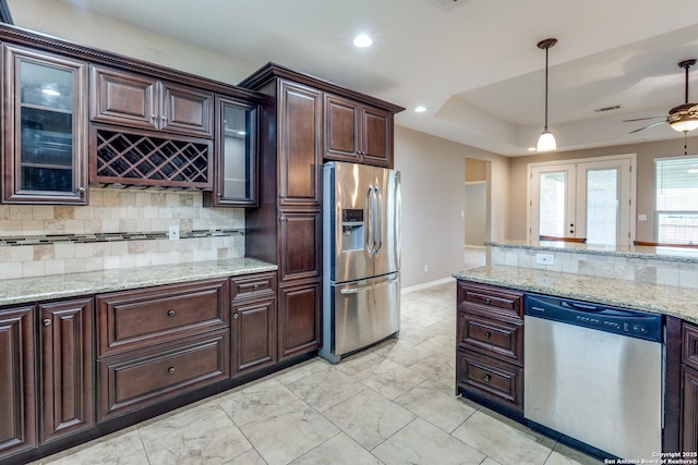 712 Crestview, Floresville, TX 78114 - kitchen featuring appliances with stainless steel finishes, decorative backsplash, dark brown cabinetry, ceiling fan, and recessed lighting