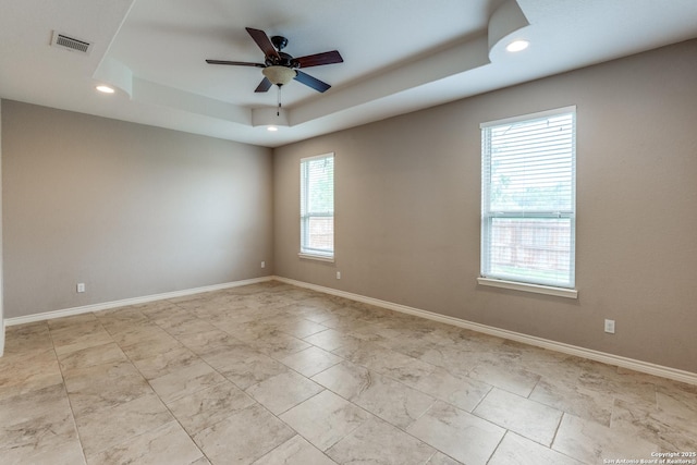 712 Crestview, Floresville, TX 78114 - spare room with a raised ceiling, a ceiling fan, recessed lighting, baseboards, and light marble finish flooring